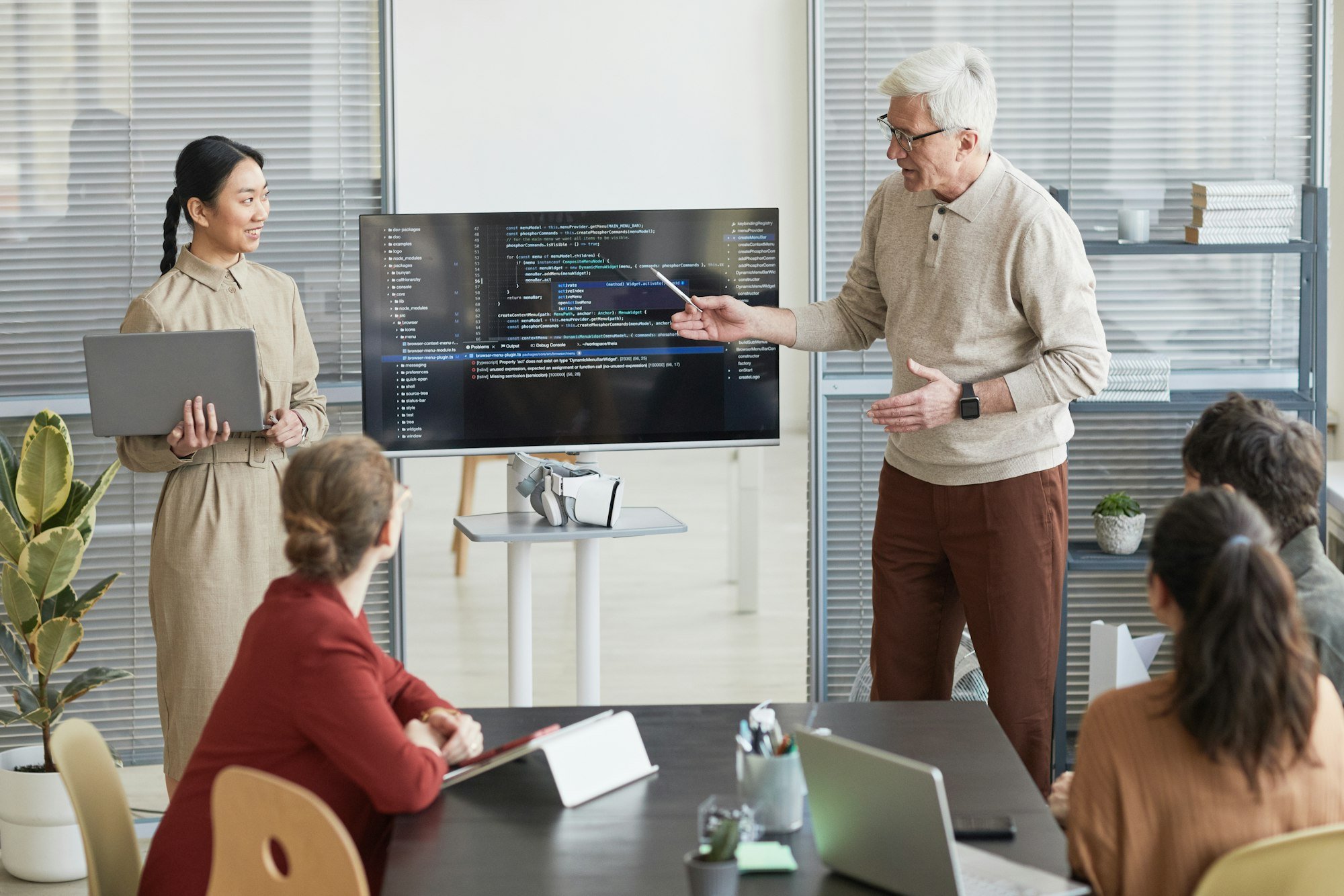 Senior Man Presenting Code